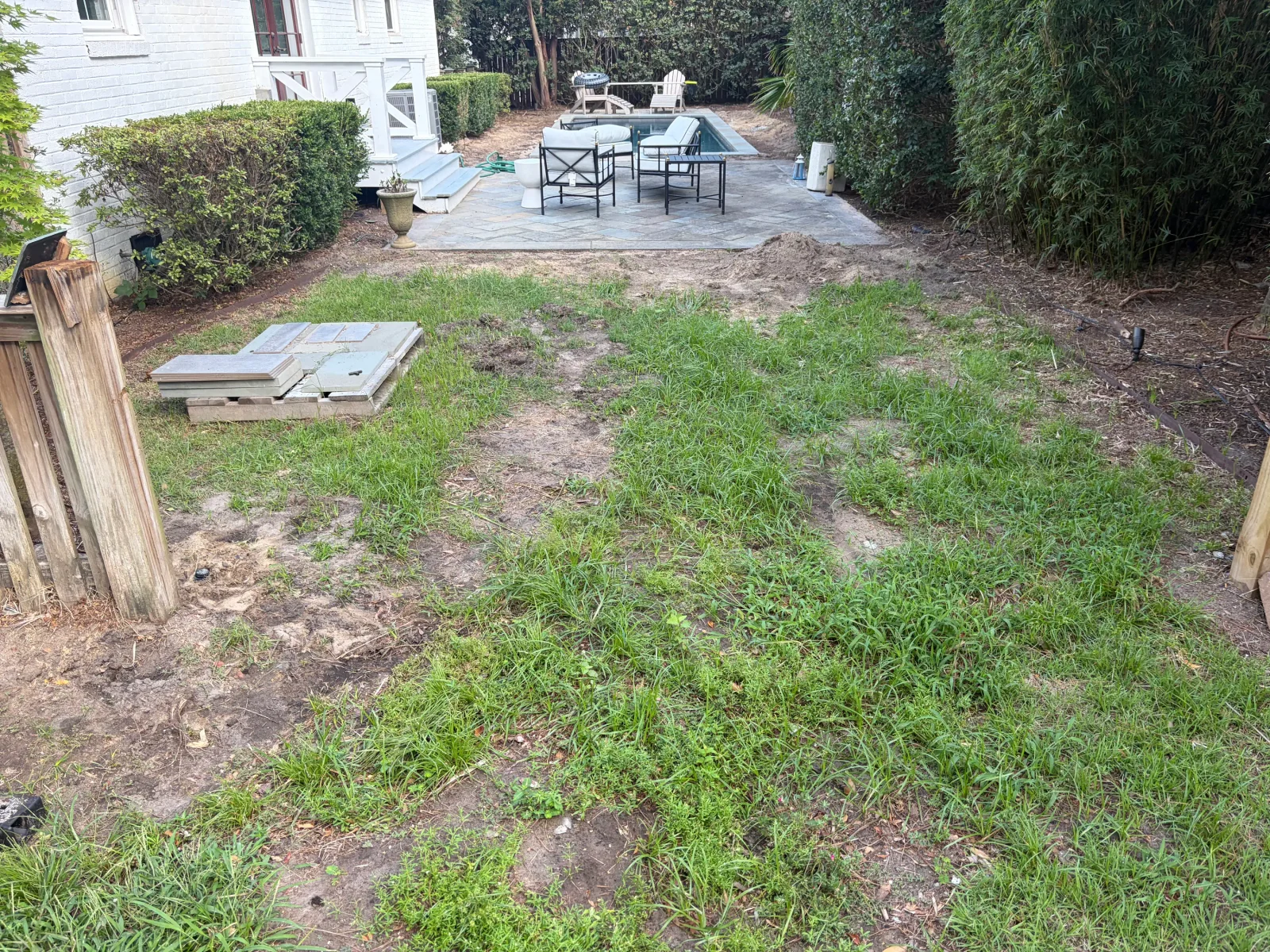 Residential golf course with putting green, sand bunker, fairway turf, and patio seating area